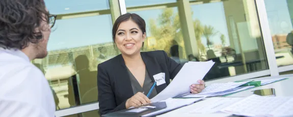Earn your bachelors and masters degree in 5 years. Female student in business suit at interview